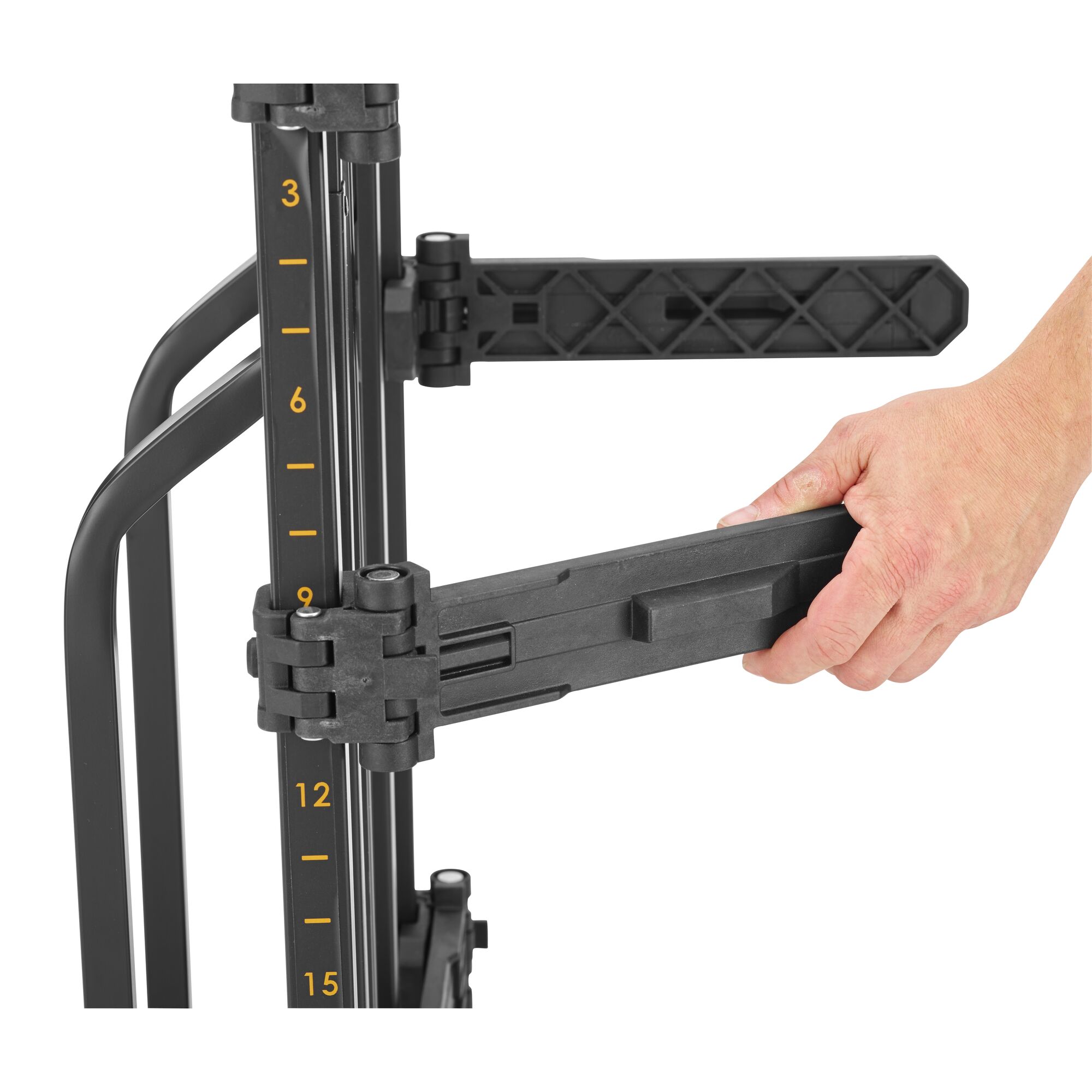 Close-up of a hand adjusting the arm of a DEWALT mobile storage cart. The vertical frame has height markings in yellow and two black plastic adjustable arms.