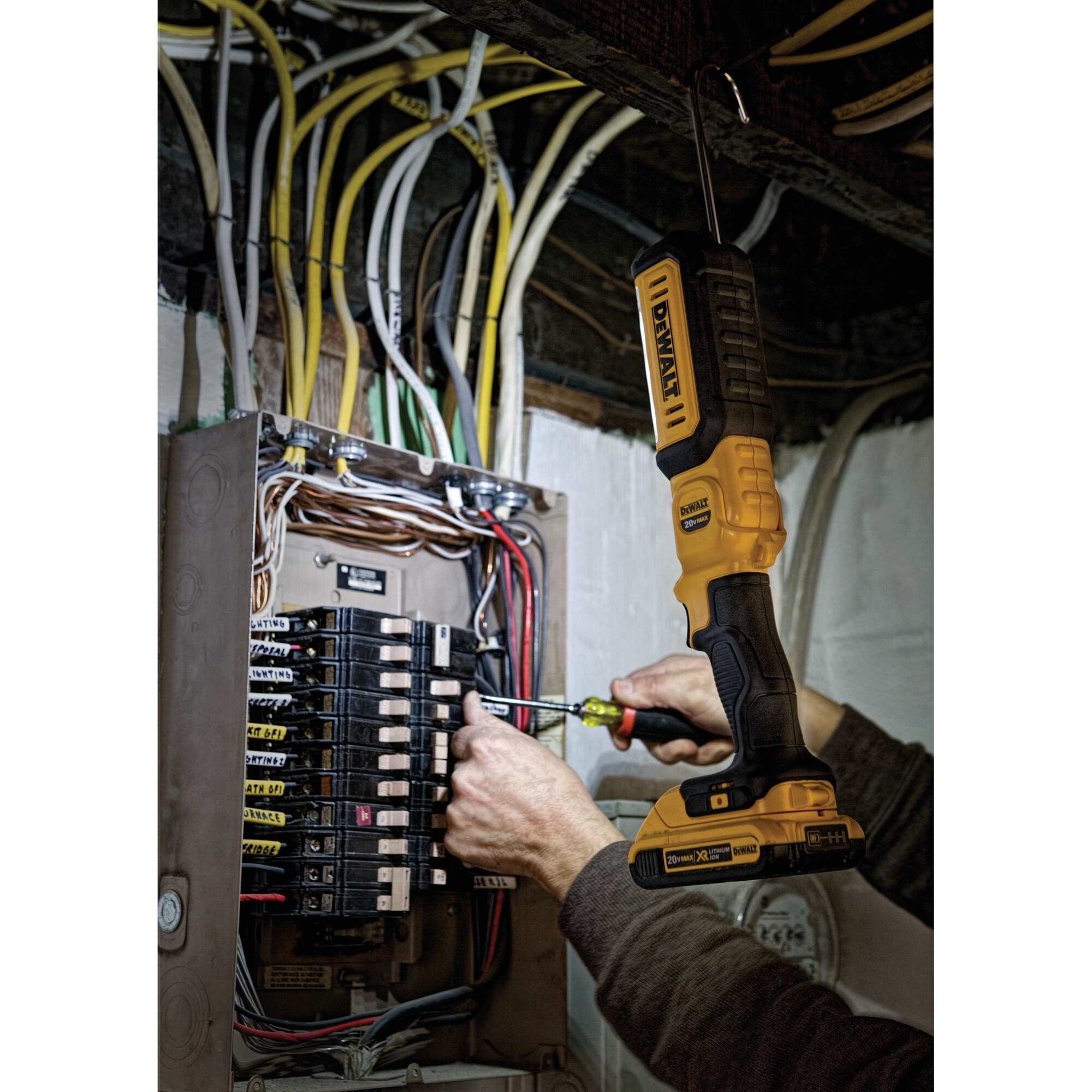 LED hand held area light being used by a person