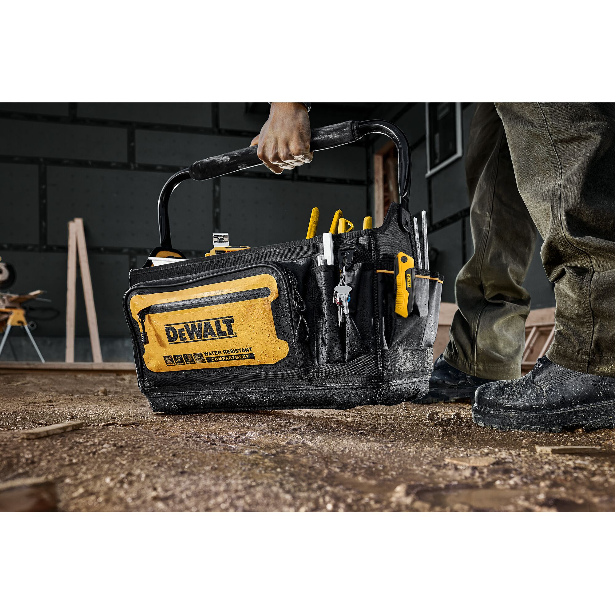 Dewalt 20" Pro Tool Tote being placed on the ground of a construction site"