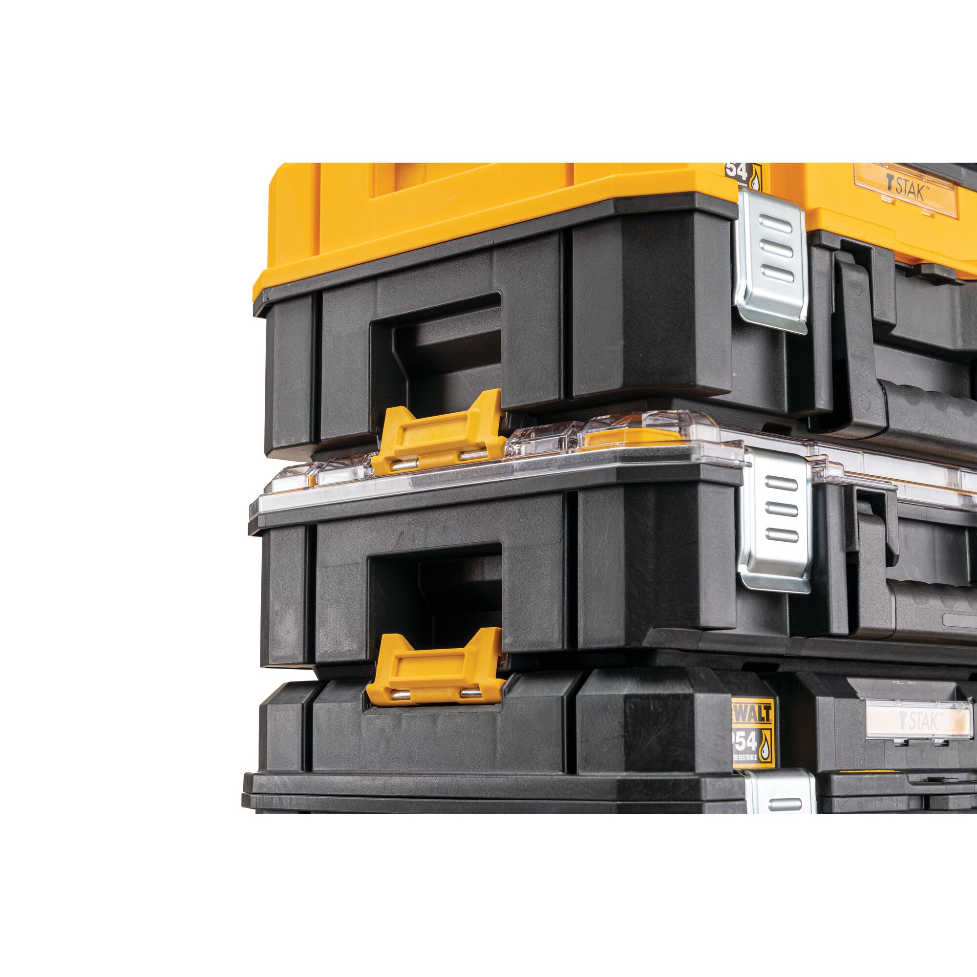 Close-up view of stacked DEWALT TSTAK-series black and yellow modular storage toolboxes with metal clasps and handles.